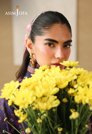 Asim Jofa AJUBC-08 campaign portrait – model in deep purple floral printed lawn holding yellow flowers near her face
