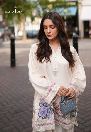 Rania Jofa Ivory Bloom RJPS-05 cream charmeuse silk floral printed shirt – upper body eyes-down London street view with floral hem and mini blue bag