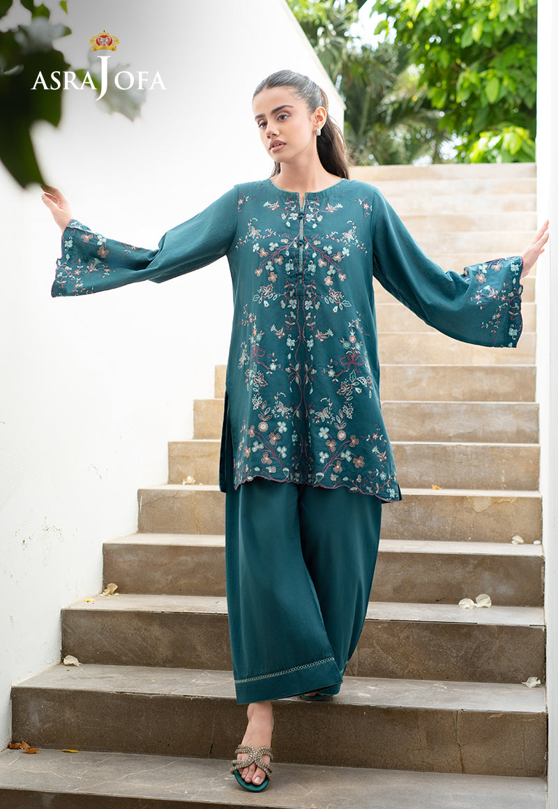 Asra Jofa ASAE-02 teal embroidered cambric 2-piece suit with bell sleeves â€“ model posing with arms extended on stairs
