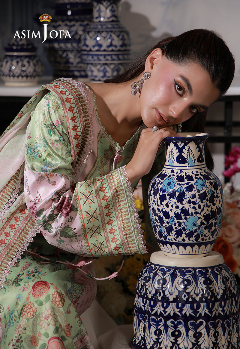 Asim Jofa AJCS-01 mint green printed charmeuse silk shirt – leaning portrait beside a ceramic vase, highlighting floral cuff