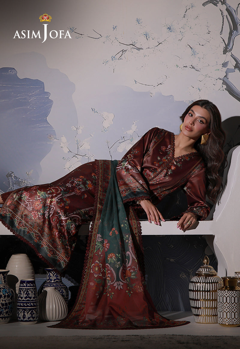 Asim Jofa AJCS-02 chocolate brown floral printed charmeuse silk suit – reclining pose on a white bench with draped silk dupatta