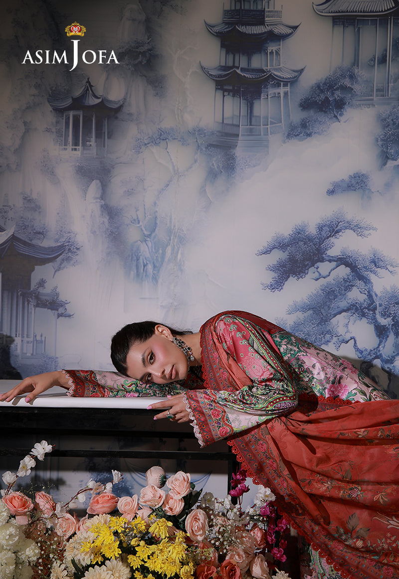 Asim Jofa AJCS-04 pink ombre printed charmeuse silk suit – model resting her head on a table with coral dupatta draped beside her
