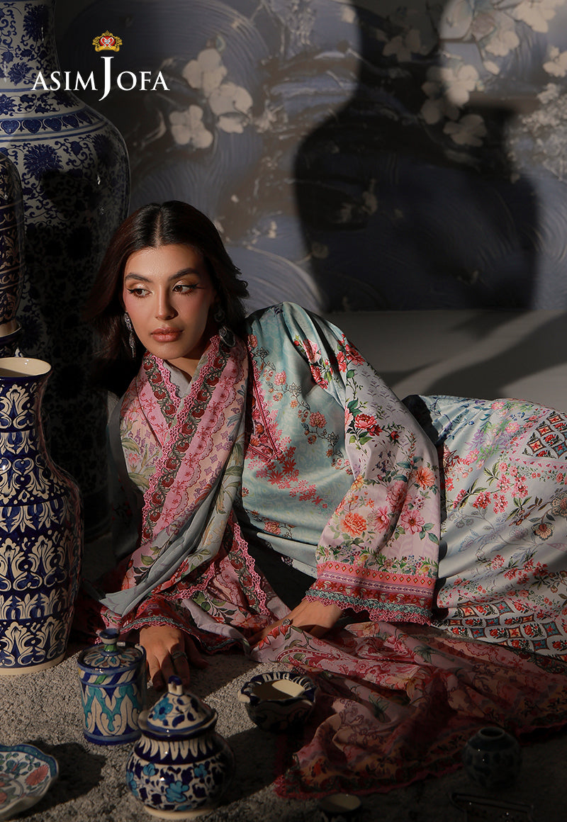 Asim Jofa AJCS-05 mint blue floral printed charmeuse silk suit – reclining view with pink dupatta beside decorative ceramic jars
