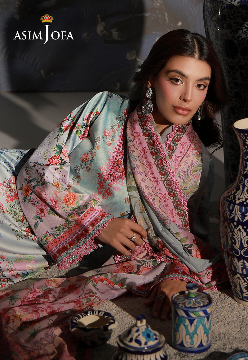 Asim Jofa AJCS-05 mint blue printed charmeuse silk suit – reclining close-up showing floral sleeves and pink dupatta border