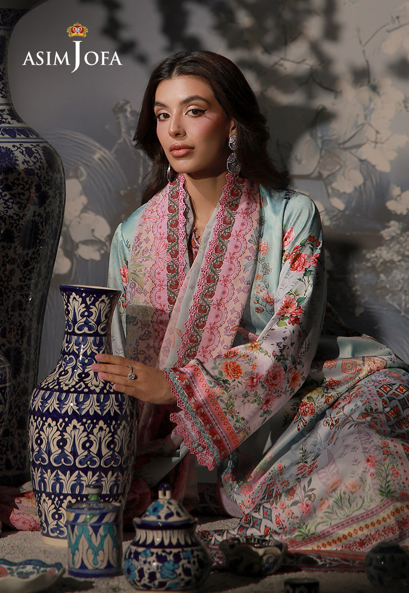 Asim Jofa AJCS-05 mint blue printed charmeuse silk suit – seated view with pink floral dupatta beside a blue and white vase