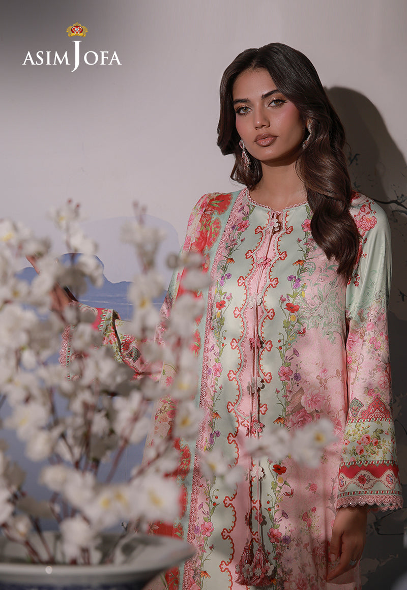 Asim Jofa AJCS-10 peach printed charmeuse silk shirt – upper-body portrait behind white blossoms showing floral neckline