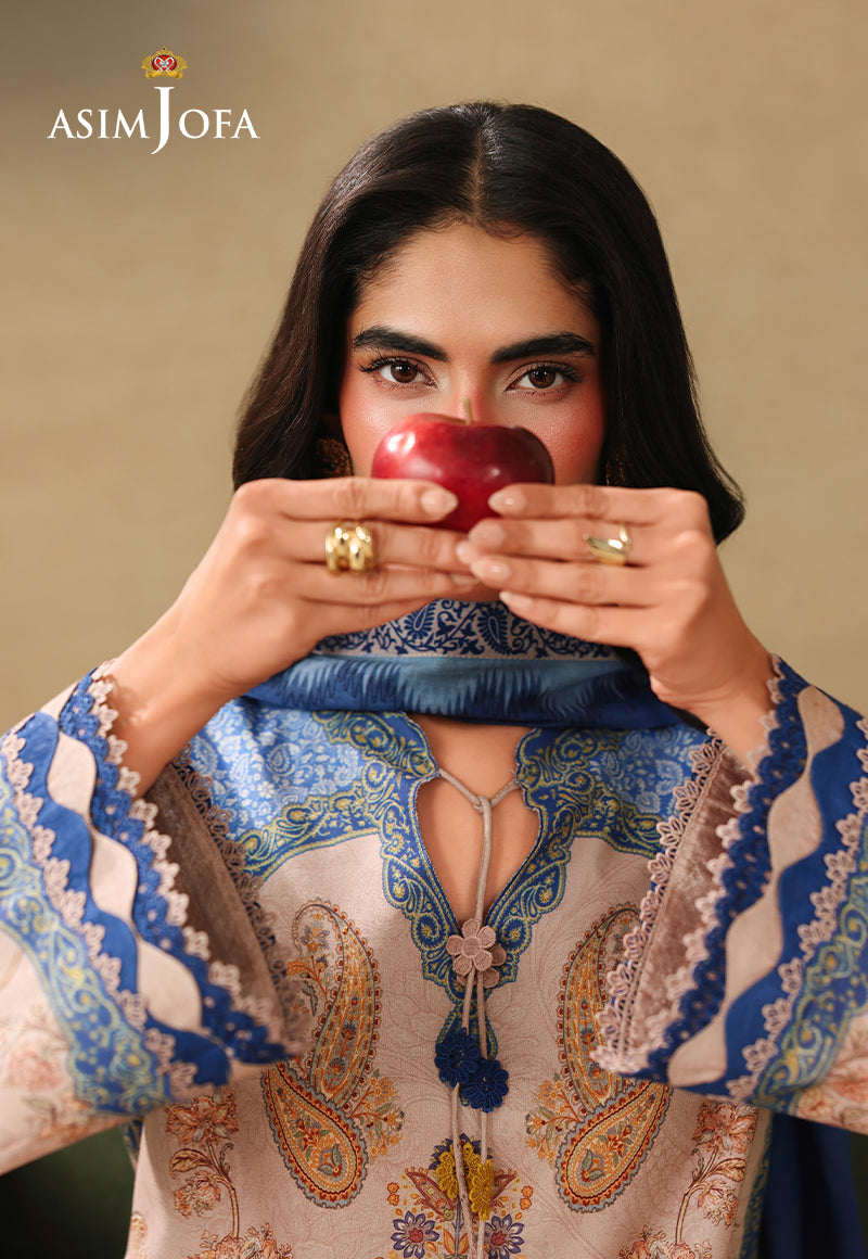 Asim Jofa AJUBC-05 light peach paisley printed lawn shirt – close-up of blue cuff borders with model holding an apple