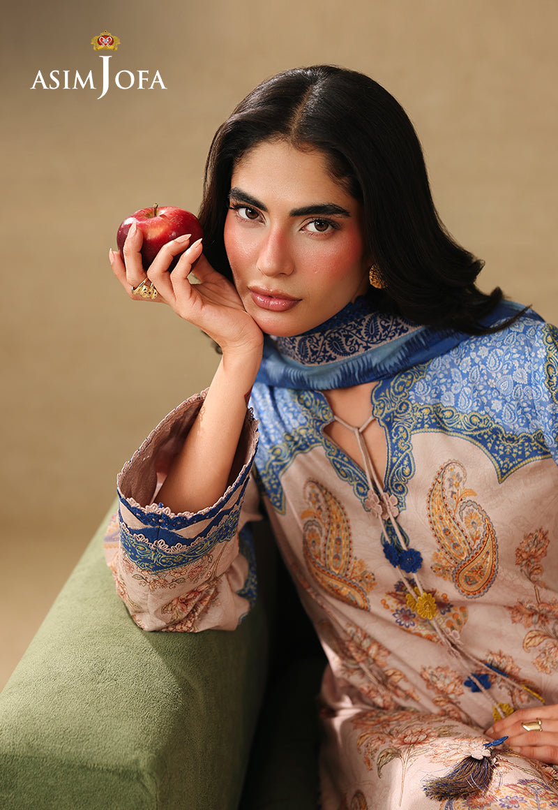 Asim Jofa AJUBC-05 light peach paisley printed lawn shirt – seated close-up of blue neckline with model holding an apple