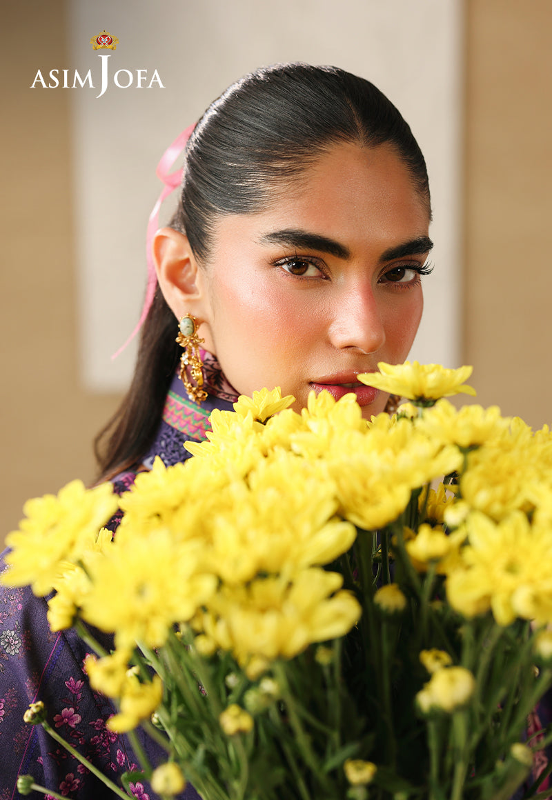 Asim Jofa AJUBC-08 campaign portrait – model in deep purple floral printed lawn holding yellow flowers near her face