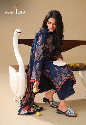 Asim Jofa AJUBC-10 navy blue printed lawn 3-piece suit – seated full-length view with model reaching down to pick up a lemon