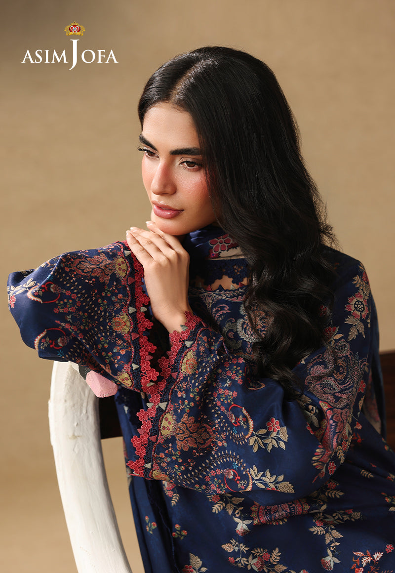 Asim Jofa AJUBC-10 navy blue printed lawn shirt – seated portrait highlighting floral sleeves and coral cuff trim
