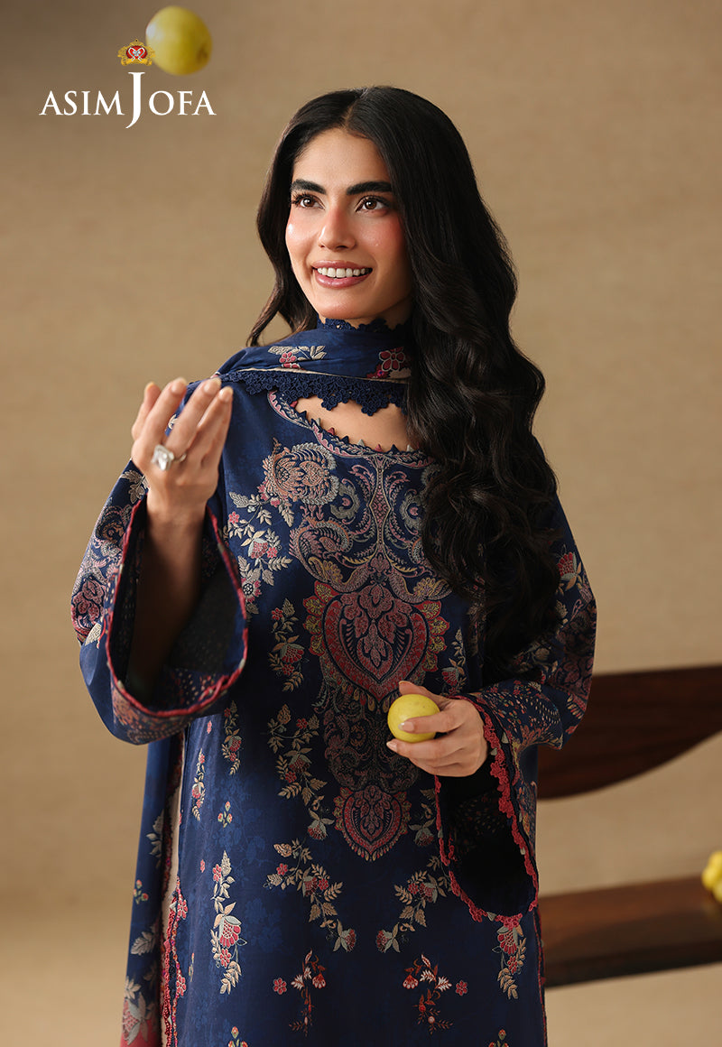 Asim Jofa AJUBC-10 navy blue printed lawn shirt – upper-body view with model tossing a lemon, showing patterned neckline
