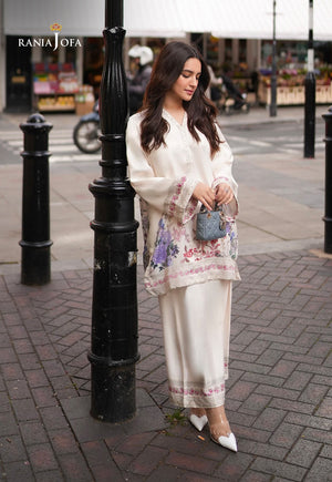 Rania Jofa Ivory Bloom RJPS-05 cream charmeuse silk floral printed co-ord set – full length eyes-down London street view holding mini blue bag