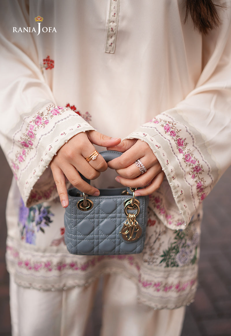 Rania Jofa Ivory Bloom RJPS-05 cream charmeuse silk shirt – close-up of floral embroidered bell cuffs with gold rings and blue mini bag detail